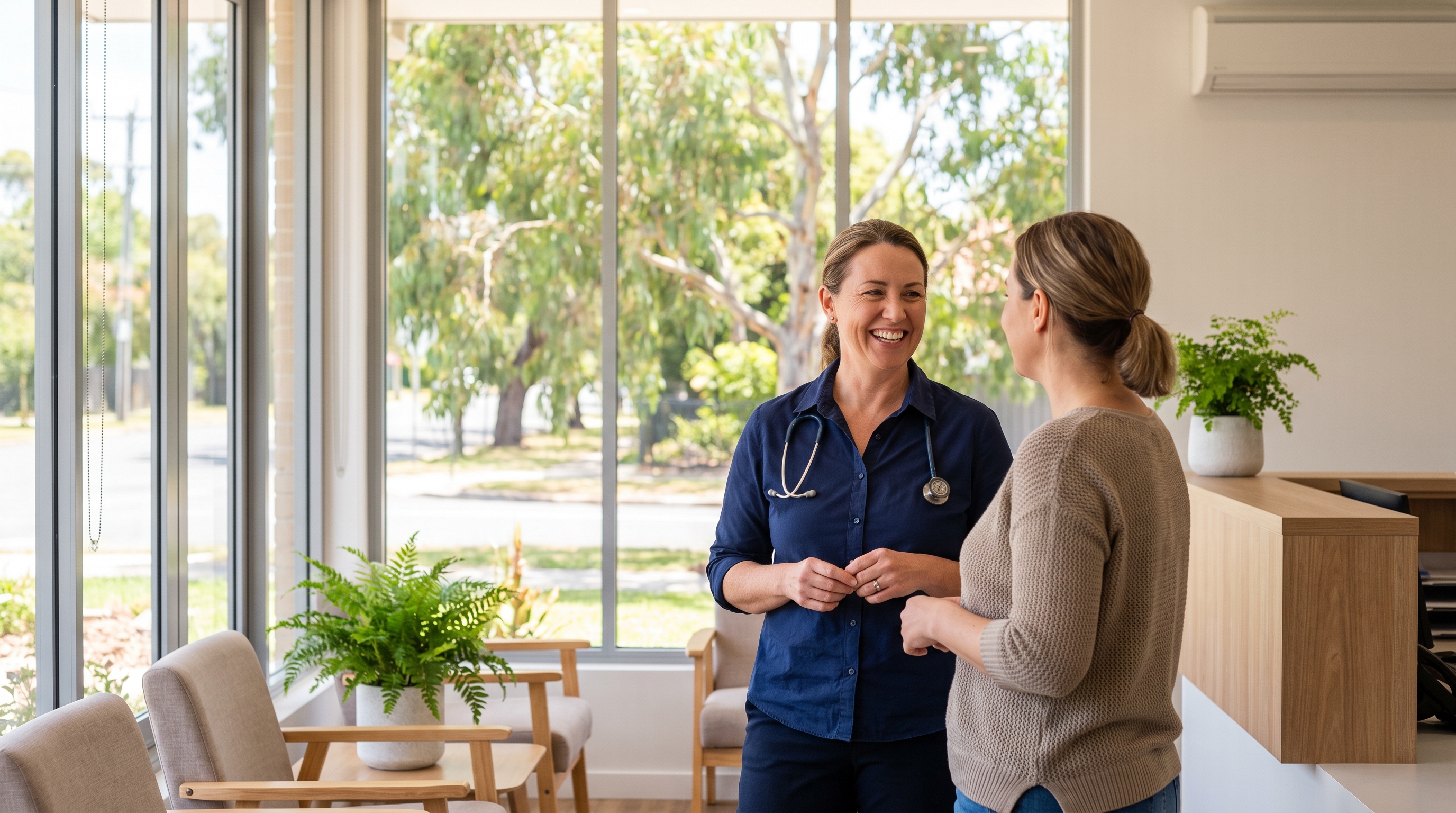 An Australian GP talking with a colleague in a bright suburban general practice